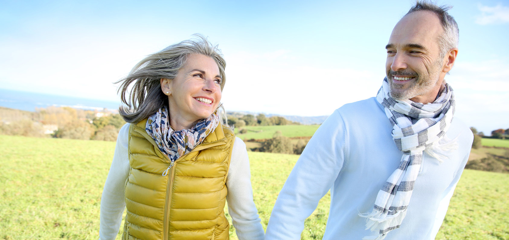 Couple holding hands in the fields